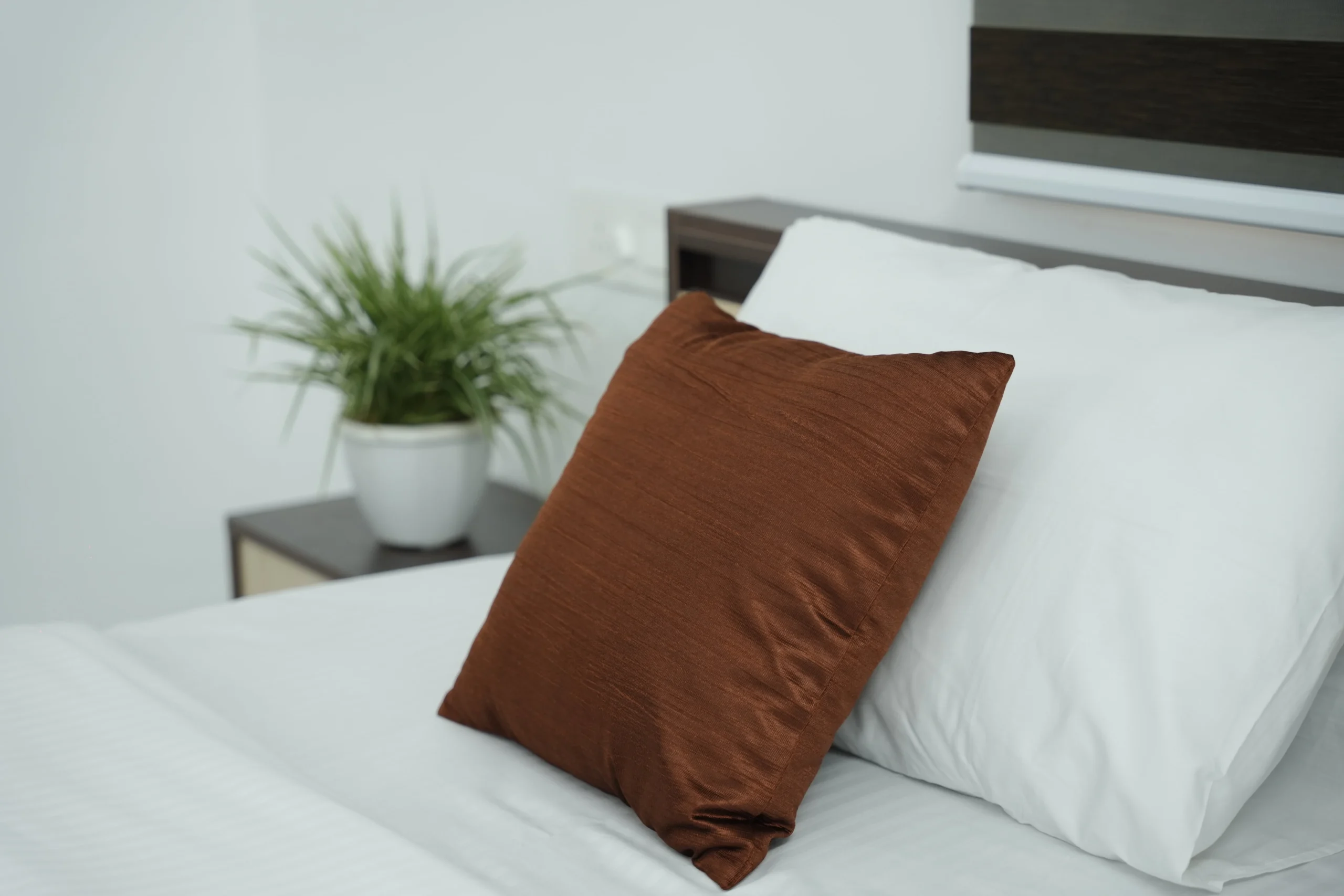 Cozy bed setup at Gold Suite Kakkanad with soft pillows and clean linens — comfortable rooms near Infopark Kochi